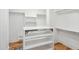 This custom walk-in closet has wood flooring and open shelving at 3 Cross Ln, Isle of Palms, SC 29451