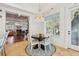 Bright dining area with a modern chandelier, round table, and a view into the living room at 3 Cross Ln, Isle of Palms, SC 29451