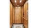 Residential elevator featuring wood paneling and mosaic tile flooring for easy access at 3 Cross Ln, Isle of Palms, SC 29451