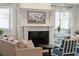 Living room fireplace with elegant mantel, artwork, hardwood floors, and light colored sofas at 3 Cross Ln, Isle of Palms, SC 29451
