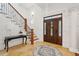 Elegant foyer showcasing a beautiful wood door, staircase, and tile floor at 3 Cross Ln, Isle of Palms, SC 29451