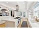 Spacious, all-white kitchen with a large island, high-end appliances, and travertine tile flooring at 3 Cross Ln, Isle of Palms, SC 29451