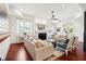 Bright and airy living room with hardwood floors, fireplace, comfortable seating, and French doors at 3 Cross Ln, Isle of Palms, SC 29451