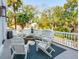 Relaxing patio area with white seating, ideal for gatherings under the surrounding trees at 3 Cross Ln, Isle of Palms, SC 29451