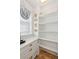 Well-organized pantry with white shelving, countertop, and drawers, plus a charming window at 3 Cross Ln, Isle of Palms, SC 29451