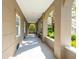 Inviting covered porch showcasing arched columns and tropical landscaping at 3 Cross Ln, Isle of Palms, SC 29451