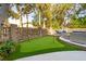 Backyard putting green bordered by landscaping and a brick retaining wall at 3 Cross Ln, Isle of Palms, SC 29451