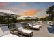 Well-appointed rooftop deck with sun loungers and umbrellas showcasing amazing sunset views at 3 Cross Ln, Isle of Palms, SC 29451