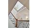 Looking up from foyer to staircase with decorative iron railings and chandelier above at 3 Cross Ln, Isle of Palms, SC 29451