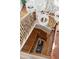 View of a stylish multi-story foyer with beautiful wood staircase and dark iron railing at 3 Cross Ln, Isle of Palms, SC 29451