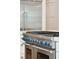 Professional grade stainless steel range with blue knobs, double oven, and a white countertop at 3 Cross Ln, Isle of Palms, SC 29451