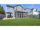 Spacious backyard with a screened porch, patio area, and lush green lawn at 301 Dunlin Dr, Summerville, SC 29486