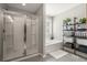 Bright bathroom featuring a separate shower and tub, complemented by stylish shelves and plants at 301 Dunlin Dr, Summerville, SC 29486