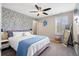 Bedroom with patterned accent wall, ceiling fan, and window with plantation shutters at 301 Dunlin Dr, Summerville, SC 29486