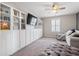 Stylish bonus room with custom built-ins, a ceiling fan, and comfortable seating area at 301 Dunlin Dr, Summerville, SC 29486