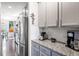Well-equipped kitchen with granite counters, stainless steel refrigerator, and coffee station at 301 Dunlin Dr, Summerville, SC 29486