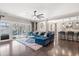 Bright and open living room featuring a comfortable blue sectional, large windows, and hardwood floors at 301 Dunlin Dr, Summerville, SC 29486