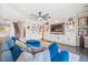 Stylish living room featuring custom built-ins, a ceiling fan, and a comfortable blue sectional sofa at 301 Dunlin Dr, Summerville, SC 29486