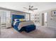 Spacious main bedroom featuring a blue accent wall, ceiling fan, and large windows with natural light at 301 Dunlin Dr, Summerville, SC 29486