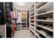 Organized walk-in closet with shelves and hanging rods to maximize storage and space efficiency at 301 Dunlin Dr, Summerville, SC 29486