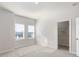 Bright, carpeted bedroom features natural light from two windows and a closet at 304 Pathfinder Way, Charleston, SC 29492