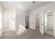 Bright, carpeted bedroom with open doorway and view to stairwell and ensuite bathroom at 304 Pathfinder Way, Charleston, SC 29492