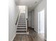 Modern entryway with wood-look flooring and staircase, showcasing bright, neutral tones at 304 Pathfinder Way, Charleston, SC 29492