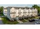 Angled exteriors of townhomes featuring balconies, neutral colors, and professional landscaping at 304 Pathfinder Way, Charleston, SC 29492