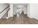 Open-concept living space with hardwood floors, a staircase, and a modern kitchen at 304 Pathfinder Way, Charleston, SC 29492