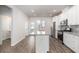 Modern kitchen featuring white cabinetry, a gray backsplash, and stainless steel appliances at 304 Pathfinder Way, Charleston, SC 29492