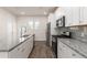 Bright kitchen featuring stainless steel appliances, stone countertops, and white cabinetry at 304 Pathfinder Way, Charleston, SC 29492