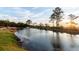 Picturesque pond reflecting the sunset with lush greenery and a fountain feature at 304 Pathfinder Way, Charleston, SC 29492