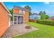Backyard featuring a charming screened porch, fire pit, patio and green lawn at 309 Harriswood Ln, Moncks Corner, SC 29461