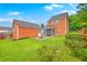 Large backyard featuring a patio, fire pit, screened porch, grass, and siding at 309 Harriswood Ln, Moncks Corner, SC 29461