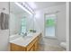 Bright bathroom featuring a single sink vanity, large mirror with vanity lighting, and a window at 309 Harriswood Ln, Moncks Corner, SC 29461