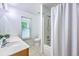 Bright bathroom with single sink vanity, tub shower with curtain, and a window at 309 Harriswood Ln, Moncks Corner, SC 29461