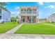 Charming two-story home featuring a double porch, a well-maintained lawn, and a welcoming walkway at 309 Harriswood Ln, Moncks Corner, SC 29461