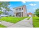 Charming two-story home with a double porch, well-maintained lawn, and detached garage at 309 Harriswood Ln, Moncks Corner, SC 29461