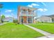 Inviting two-story home with a neat lawn and a cozy front porch with comfortable seating at 309 Harriswood Ln, Moncks Corner, SC 29461