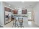 Well-lit kitchen with stainless steel appliances, bar stool seating, and a view to the backyard at 309 Harriswood Ln, Moncks Corner, SC 29461