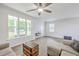 Spacious living room showcasing modern decor, a ceiling fan, large windows, and hardwood floors at 309 Harriswood Ln, Moncks Corner, SC 29461