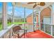 Relaxing screened porch with wicker furniture and a view of the backyard at 309 Harriswood Ln, Moncks Corner, SC 29461