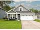 Charming single-Gathering home featuring a well-manicured lawn and a two-car garage at 3257 Timberline Dr, Johns Island, SC 29455
