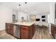 Open floorplan kitchen with island provides seamless flow to living and dining spaces at 3257 Timberline Dr, Johns Island, SC 29455