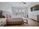 Large bedroom with a king-sized bed, hardwood floors, and large windows at 357 Tupelo Lake Dr, Summerville, SC 29486