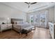 Spacious bedroom with a king-sized bed, tray ceiling, and large windows at 357 Tupelo Lake Dr, Summerville, SC 29486