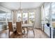 Dining room with large windows, hardwood floors, and modern chandelier at 357 Tupelo Lake Dr, Summerville, SC 29486