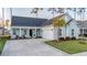 Charming single-story home with an attached garage, a covered front porch with seating, and a landscaped yard at 357 Tupelo Lake Dr, Summerville, SC 29486