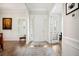 Bright foyer with hardwood floors, white trim, and natural light streaming through window shutters at 357 Tupelo Lake Dr, Summerville, SC 29486