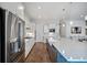 Bright, white kitchen with a large island, stainless steel appliances, and hardwood floors at 357 Tupelo Lake Dr, Summerville, SC 29486
